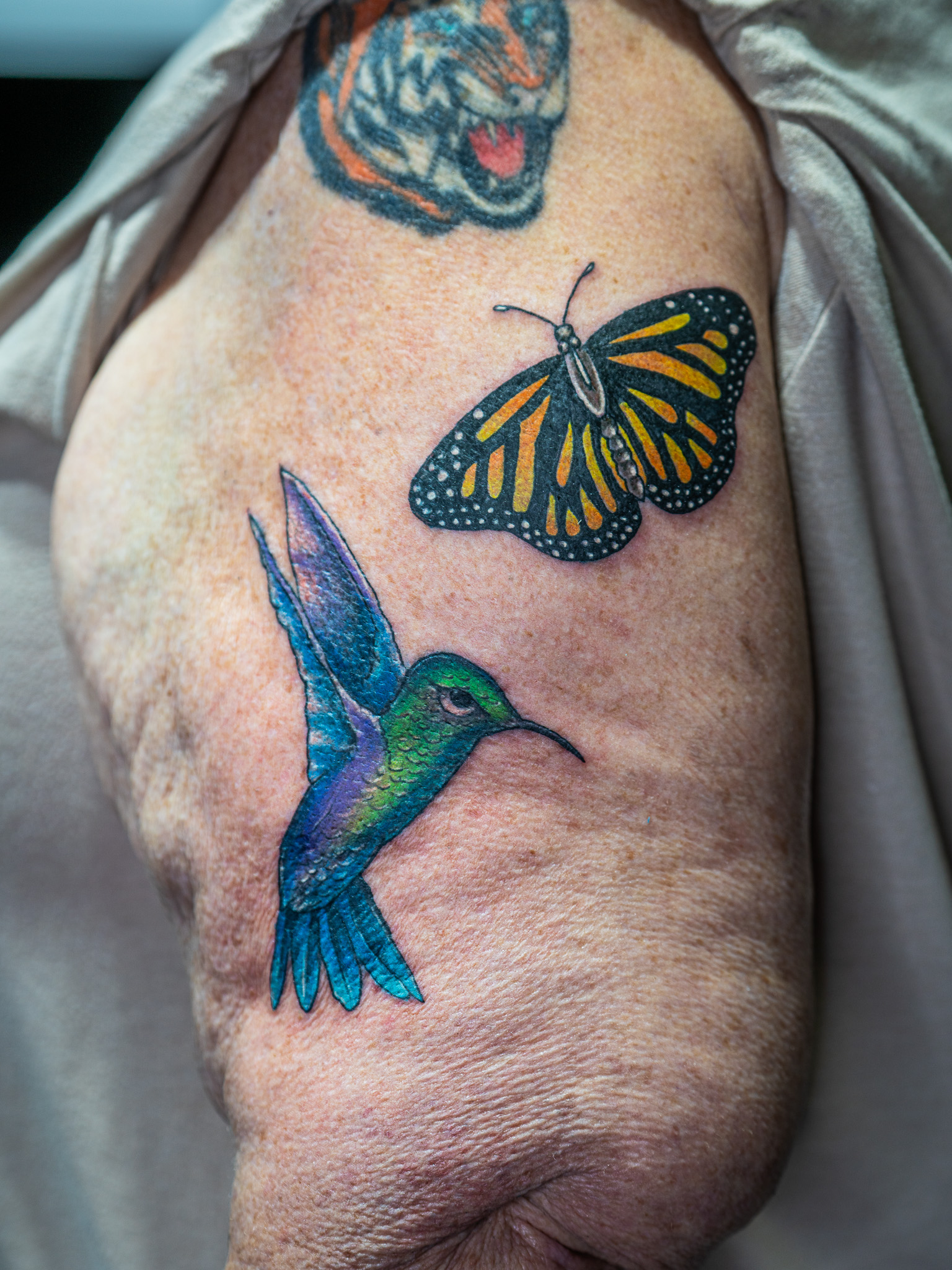 custom hummingbird and monarch butterfly tattoo by Eric Coe at Eternal Souls Tattoo Studio in Denton Texas