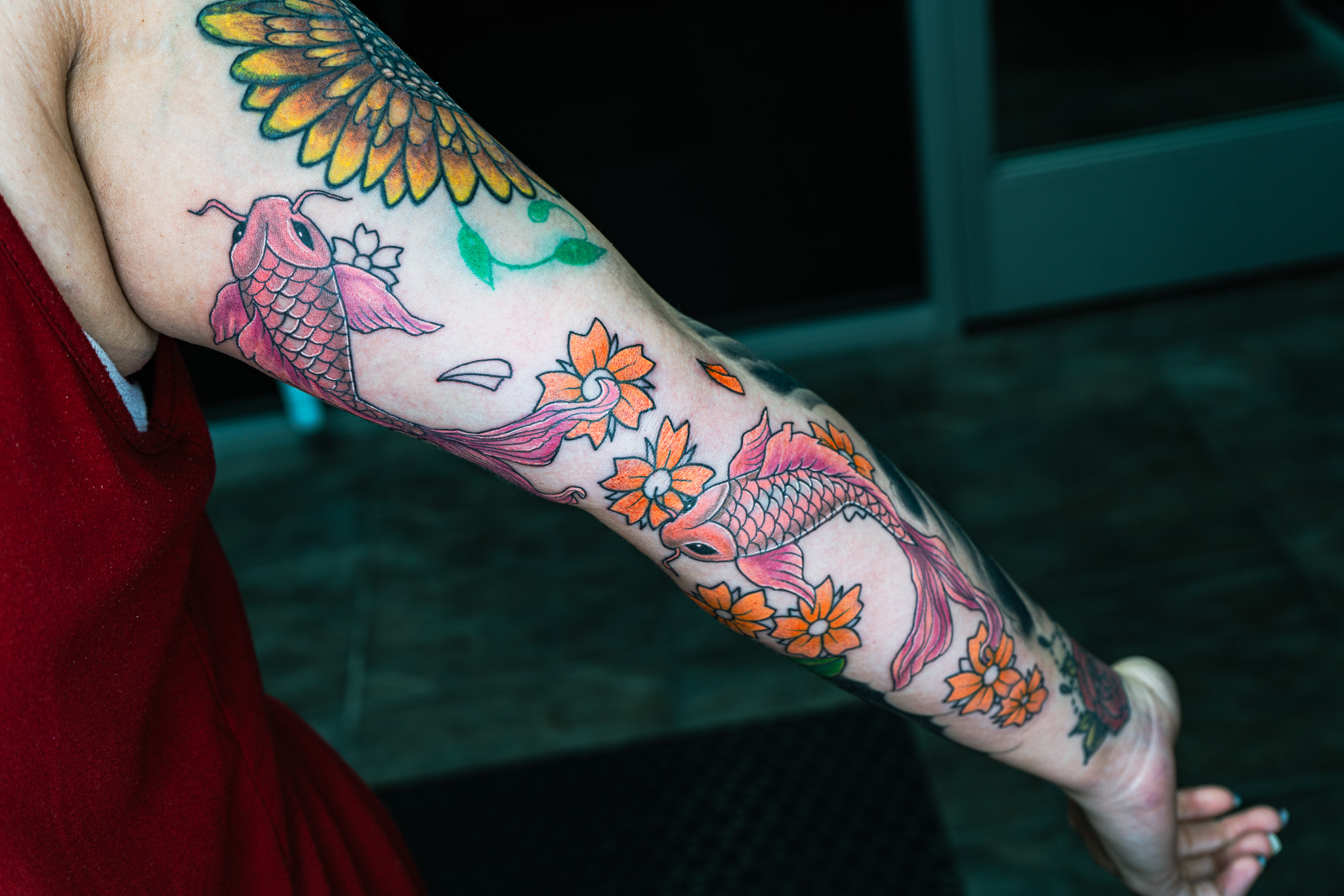 custom koi fish and floral design tattoo by Eric Coe at Eternal Souls Tattoo Studio in Dallas, Texas