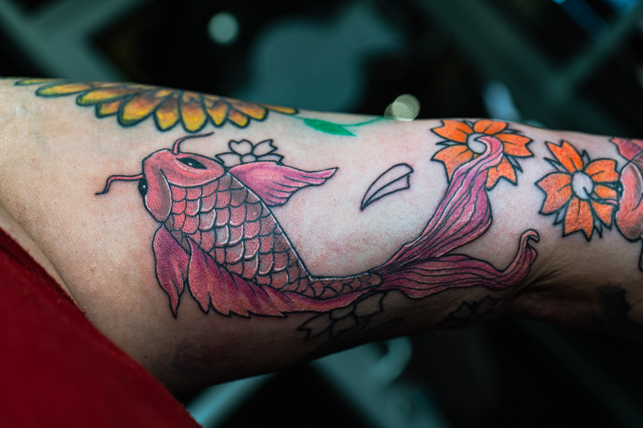 custom koi fish and floral design tattoo by Eric Coe at Eternal Souls Tattoo Studio in Dallas, Texas