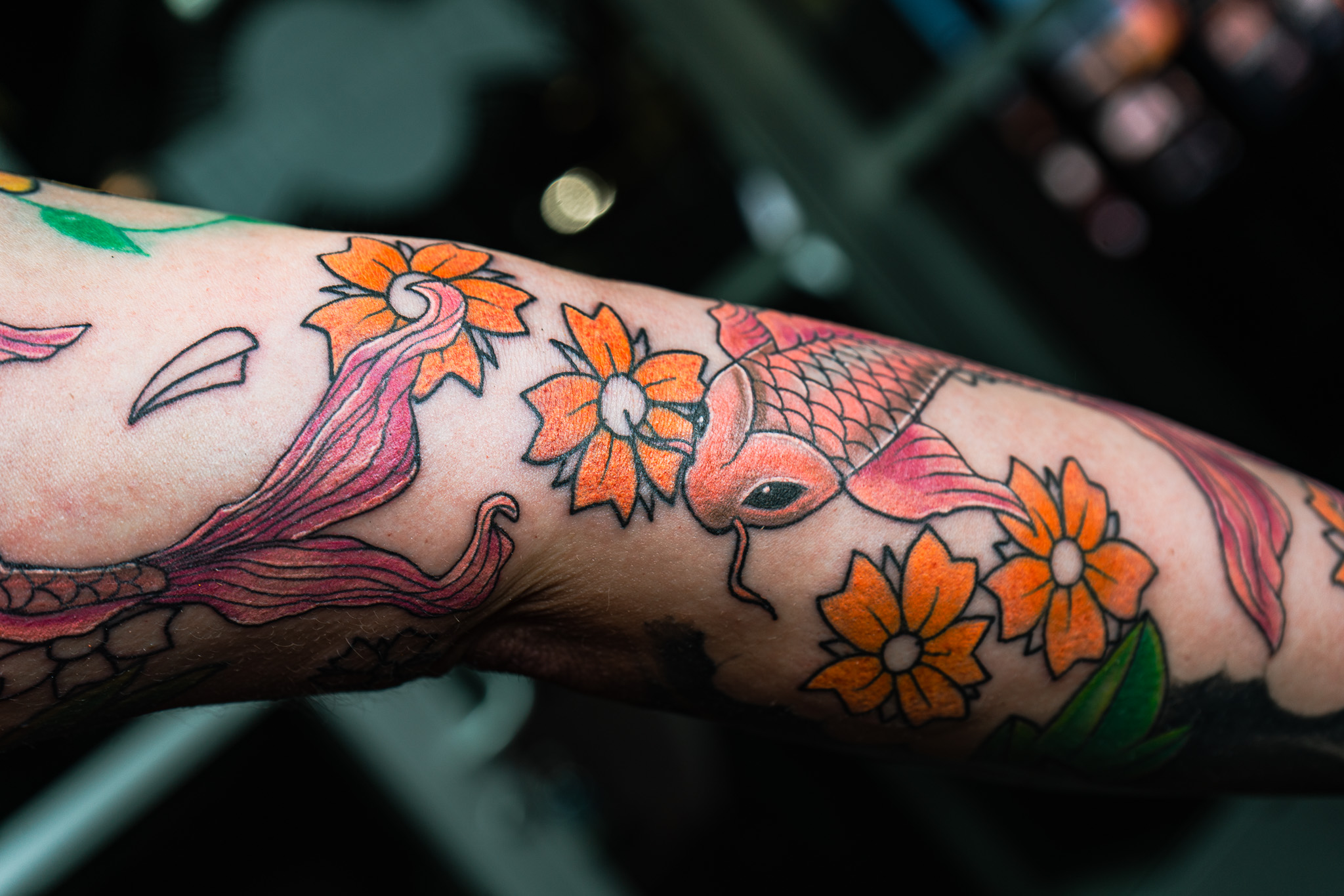 custom koi fish and floral design tattoo by Eric Coe at Eternal Souls Tattoo Studio in Dallas, Texas